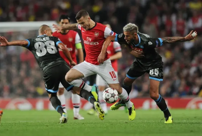 Framed Print : Arsenal's Wilshere Faces Off Against Inler and Behrami of Napoli in Champions League Clash