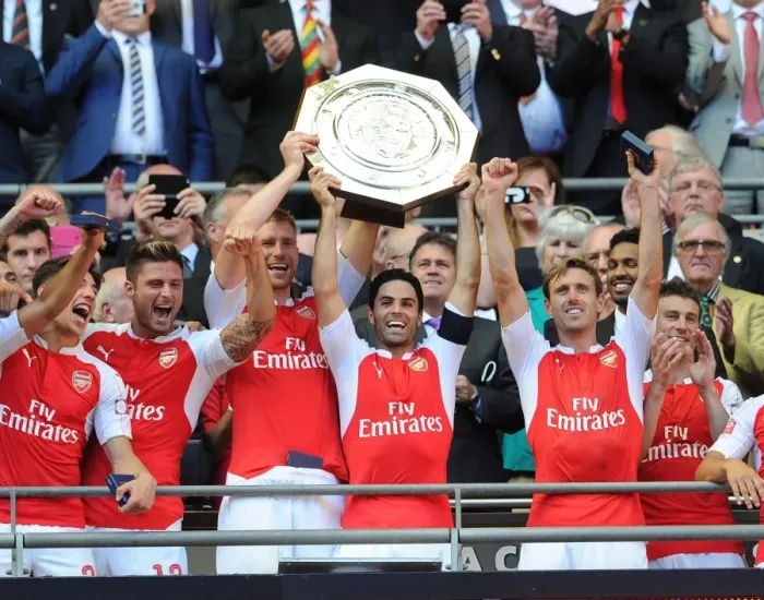Framed Print : Arsenal's Winning Squad: Mertesacker, Arteta, Monreal, and Giroud Celebrate Community Shield Victory