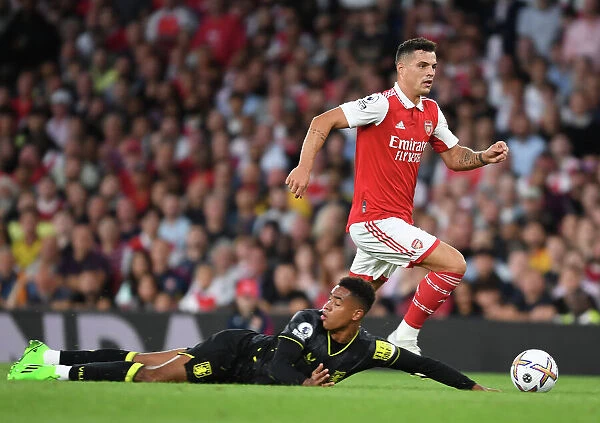 Arsenal's Xhaka Clashes with Aston Villa's Konsa in 2022-23 Premier League Showdown