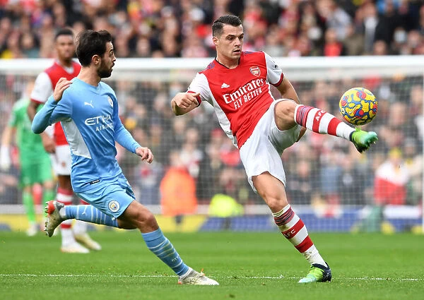 Arsenal's Xhaka Fends Off Manchester City's Silva: Premier League Clash at Emirates Stadium (January 2022)