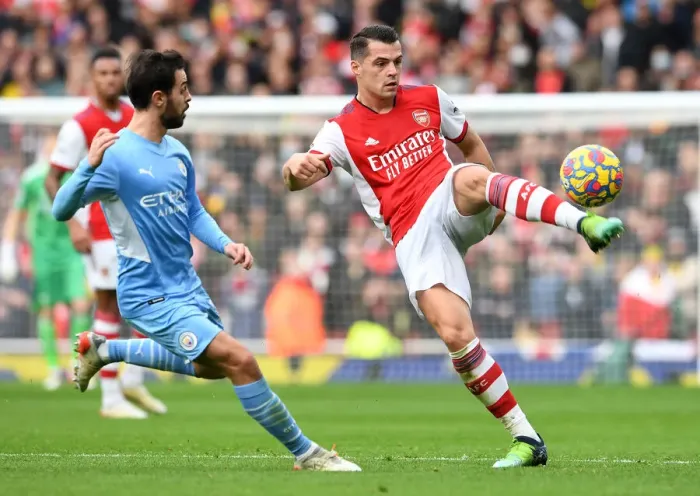 Framed Print : Arsenal's Xhaka Fends Off Manchester City's Silva: Premier League Clash at Emirates Stadium (January 2022) Framed Print : Arsenal's Xhaka Fends Off Manchester City's Silva: Premier League Clash at Emirates Stadium (January 2022)