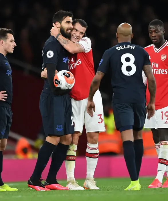 Framed Print : Arsenal's Xhaka and Gomes Embrace Amidst Premier League Rivalry Framed Print : Arsenal's Xhaka and Gomes Embrace Amidst Premier League Rivalry