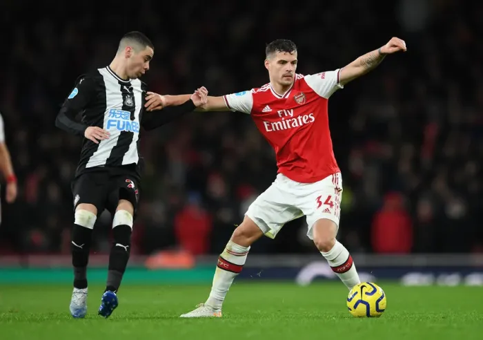 Framed Print : Arsenal's Xhaka Holds Off Newcastle's Almiron in Premier League Clash Framed Print : Arsenal's Xhaka Holds Off Newcastle's Almiron in Premier League Clash