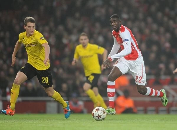 Arsenal's Yaya Sanogo Faces Off Against Borussia Dortmund's Matthias Ginter in Champions League Clash
