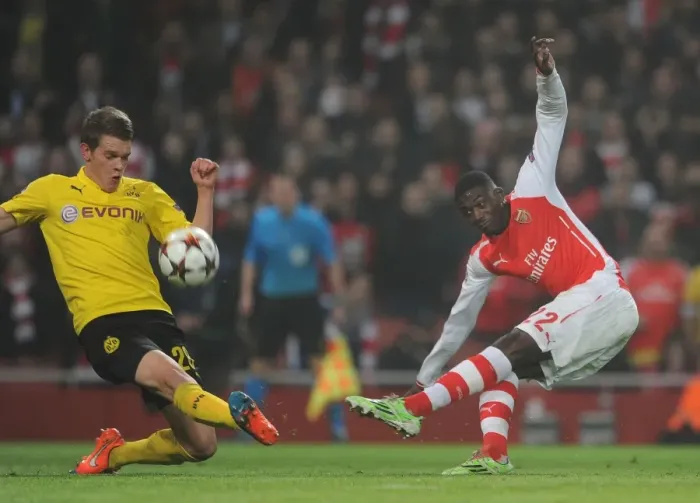 Framed Print : Arsenal's Yaya Sanogo Faces Off Against Matthias Ginter in Champions League Clash Framed Print : Arsenal's Yaya Sanogo Faces Off Against Matthias Ginter in Champions League Clash