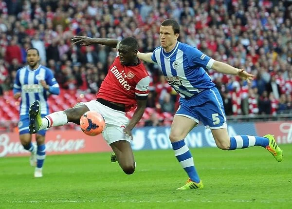 Arsenal's Yaya Sanogo Faces Off Against Wigan's Gary Cadwell in FA Cup Semi-Final Showdown