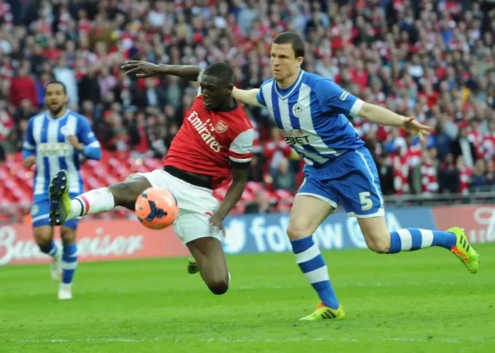 Framed Print : Arsenal's Yaya Sanogo Faces Off Against Wigan's Gary Cadwell in FA Cup Semi-Final Showdown Framed Print : Arsenal's Yaya Sanogo Faces Off Against Wigan's Gary Cadwell in FA Cup Semi-Final Showdown