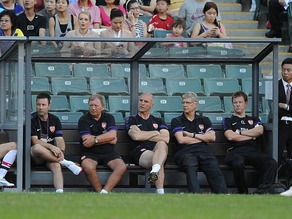 Arsene Wenger and Arsenal Coaching Team on Kitchee FC Match Bench (2012)