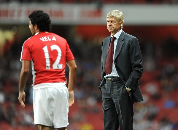 Arsene Wenger the Arsenal Manager with Carlos Vela