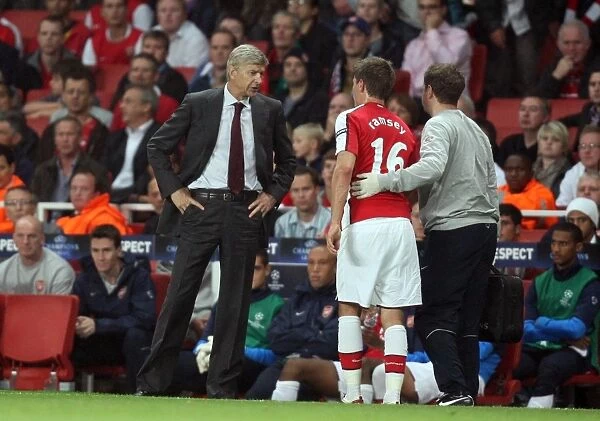 Arsene Wenger the Arsenal Manager chats to Aaron Ramsey
