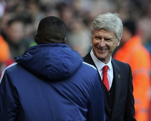 Arsene Wenger the Arsenal Manager with Guy Demel (West Ham) before the match. Arsenal 3