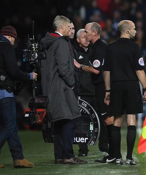 Arsene Wenger the Arsenal Manager and Referee Mike Dean. West Bromwich Albion 1:1 Arsenal