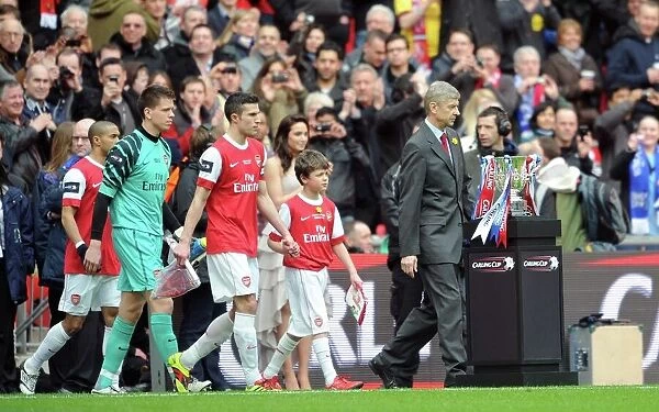 Arsene Wenger the Arsenal Manager and Robin van Persie (Arsenal) lead out the team