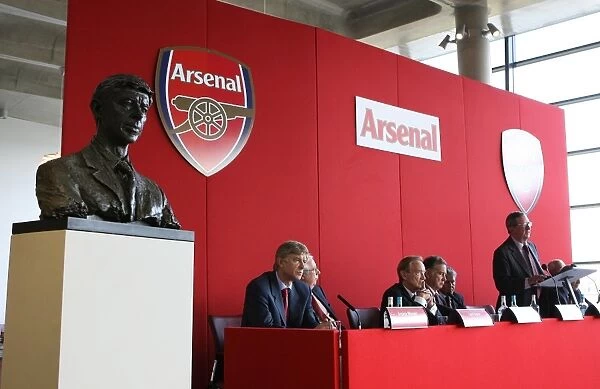 Arsene Wenger the Arsenal Manager seats next to his bust