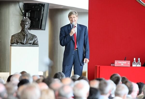 Arsene Wenger the Arsenal Manager stands next to the bust of himself