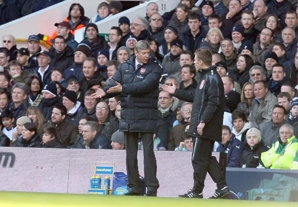 Arsene Wenger the Arsenal Manager talks with the 4th official