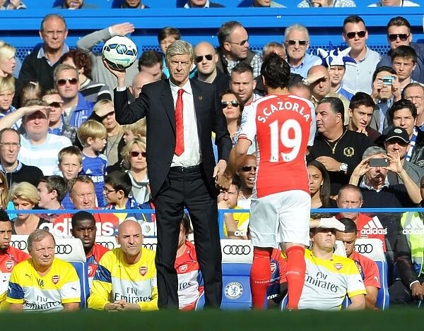 Arsene Wenger Catching Ball for Cazorla: Chelsea vs. Arsenal, Premier League 2014-15