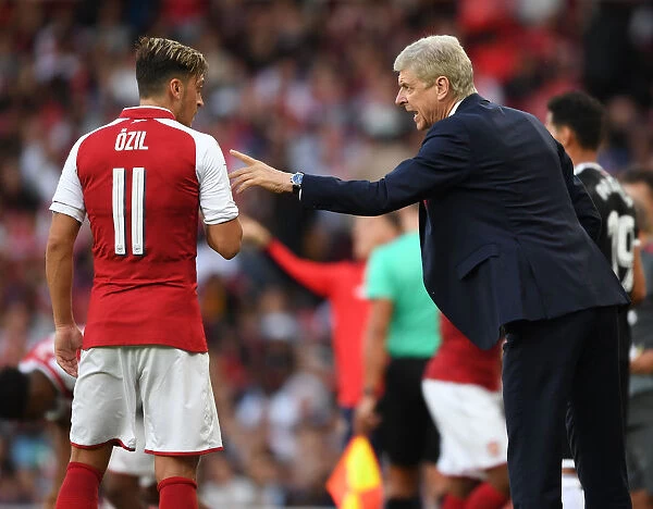 Arsene Wenger Conferring with Mesut Ozil during Arsenal's Emirates Cup Match against Sevilla, 2017
