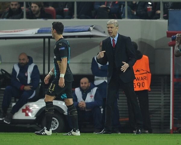 Arsene Wenger and Mesut Ozil: A Strategic Discussion Amidst the Champions League Battle (Olympiacos vs. Arsenal, 2015)