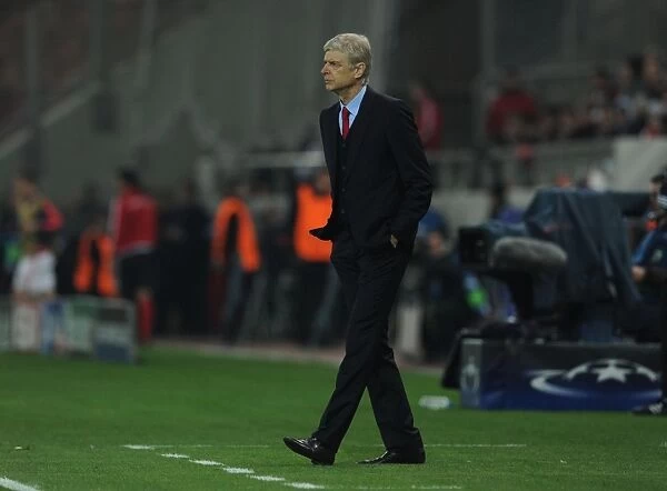 Arsene Wenger at Olympiacos vs Arsenal, UEFA Champions League 2015: A Tense Look from the Arsenal Manager's Bench in Athens