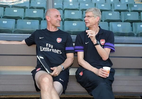 Arsene Wenger and Steve Bould Share a Laugh: Arsenal's Pre-Season Friendly against Kitchee FC (2012)