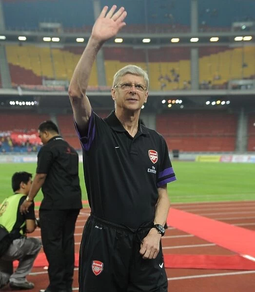Arsene Wenger Waves to Arsenal Fans Before Malaysia XI Match, 2012