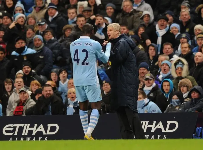 Framed Print : Arsene Wenger and Yaya Toure: A Light-Hearted Moment Amidst the Manchester City vs. Arsenal Rivalry (2011-12)