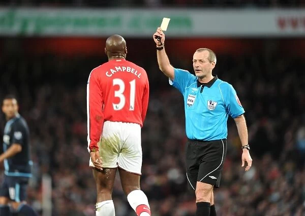 Arsenla defender Sol Campbell is shown the yellow card by referee Martin Atkinson