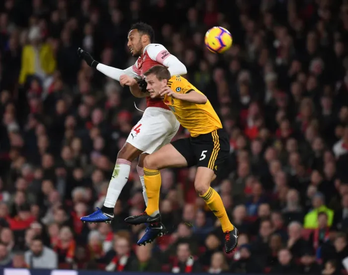 Framed Print : Aubameyang vs. Bennett: Intense Clash Between Arsenal's Star Striker and Wolves Defender