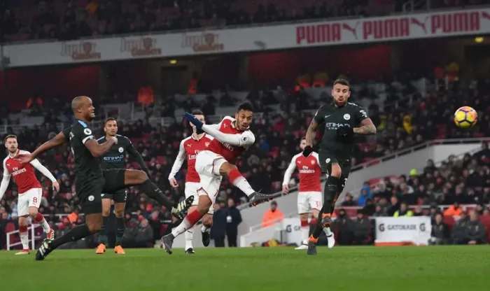Framed Print : Aubameyang vs. Otamendi and Kompany: Intense Moment from Arsenal vs. Manchester City, Premier League 2017-18