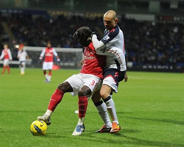 Bacary Sagna vs. Martin Petrov: Shielding the Ball in the Premier League Clash between Bolton Wanderers and Arsenal