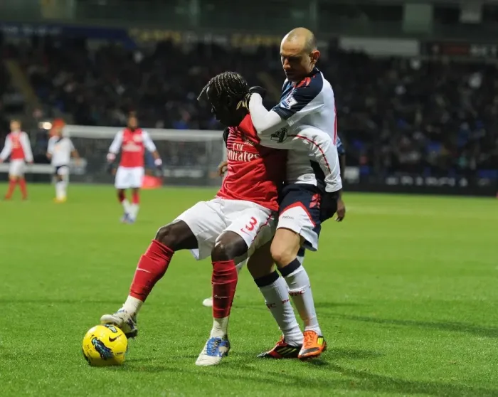 Framed Print : Bacary Sagna vs. Martin Petrov: Shielding the Ball in the Premier League Clash between Bolton Wanderers and Arsenal
