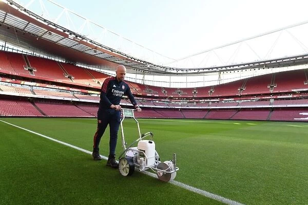 Battle Lines Drawn: Arsenal Groundsman Prepares Arsenal's Turf for the Big Match vs. Tottenham
