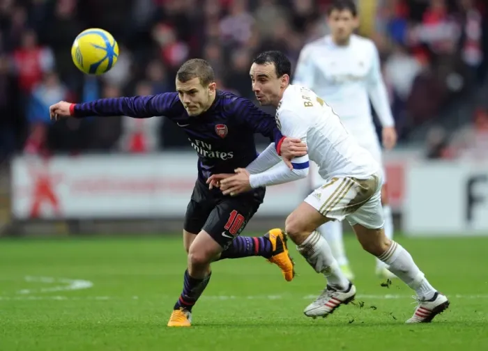 Framed Print : Battle of Midfield: Jack Wilshere vs. Leon Britton - FA Cup Showdown, 2013: Arsenal's Wilshere Outmaneuvers Swansea's Britton Framed Print : Battle of Midfield: Jack Wilshere vs. Leon Britton - FA Cup Showdown, 2013: Arsenal's Wilshere Outmaneuvers Swansea's Britton