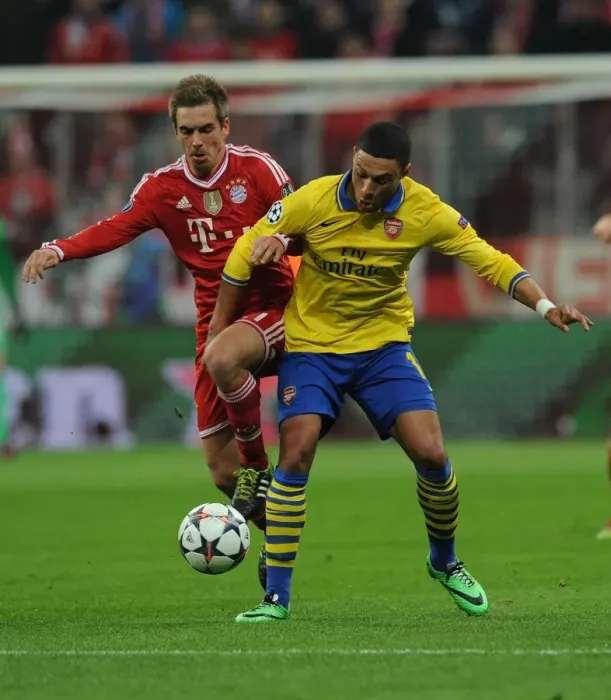 Framed Print : Battle of the Midfield: Oxlade-Chamberlain vs. Lahm - Arsenal's Ox Takes on Bayern's Maestro in the UEFA Champions League