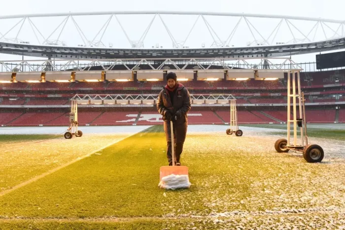 Framed Print : Braving the Blizzard: Arsenal's Heroic Snow Clearance before Manchester City Showdown Framed Print : Braving the Blizzard: Arsenal's Heroic Snow Clearance before Manchester City Showdown