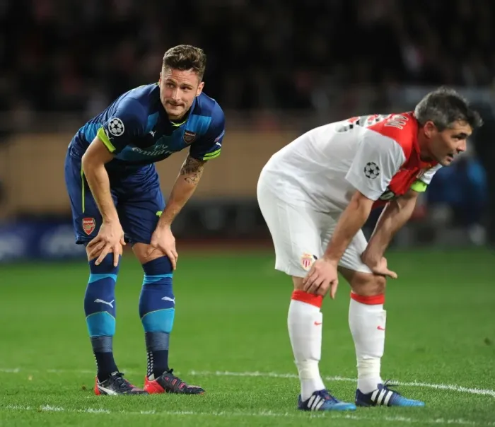 Framed Print : Breathless Moment: Olivier Giroud and Jeremy Toulalan Lock Eyes During Intense Monaco vs. Arsenal UCL Clash