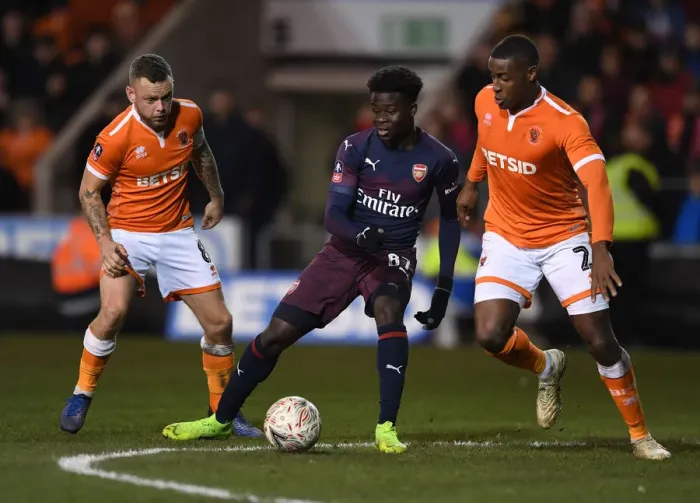 Framed Print : Bukayo Saka Clashes with Blackpool Defenders in FA Cup Third Round Showdown