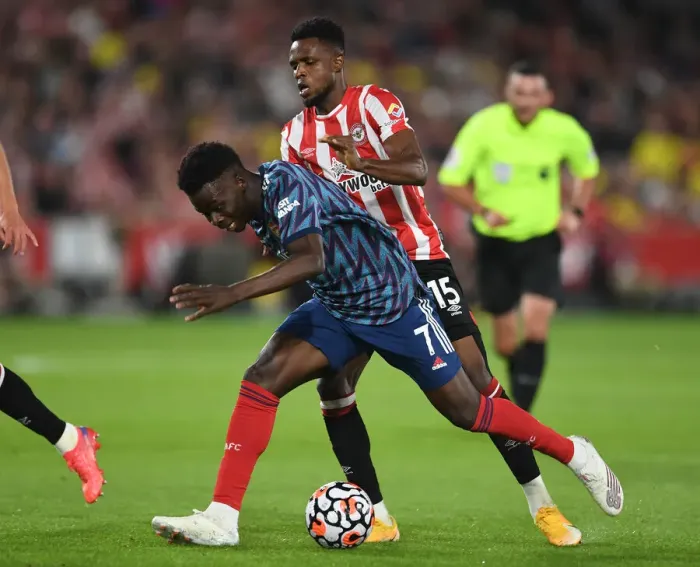 Framed Print : Bukayo Saka Clashes with Frank Onyeka: Intense Moment from Brentford vs. Arsenal, 2021-22 Premier League