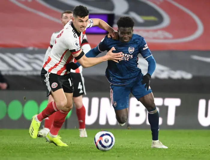 Framed Print : Bukayo Saka Darts Past Sheffield United's John Egan in Empty Bramall Lane - Arsenal vs Sheffield United, Premier League 2020-21