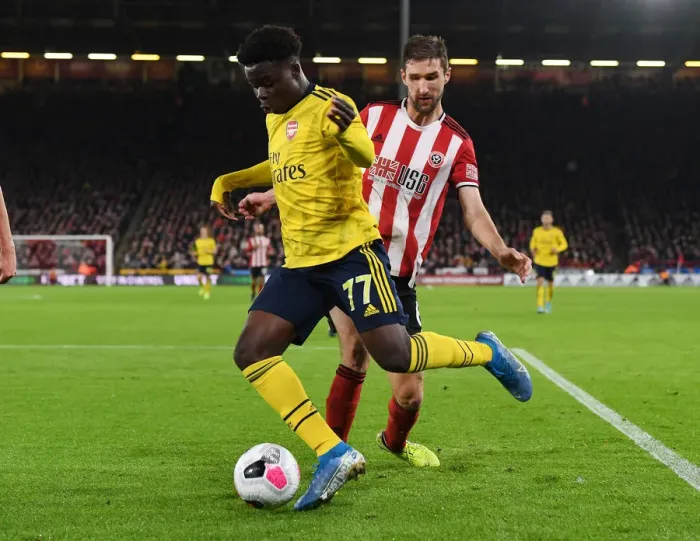Framed Print : Bukayo Saka Dashes Past Chris Basham: Sheffield United vs. Arsenal, Premier League 2019-20 Framed Print : Bukayo Saka Dashes Past Chris Basham: Sheffield United vs. Arsenal, Premier League 2019-20