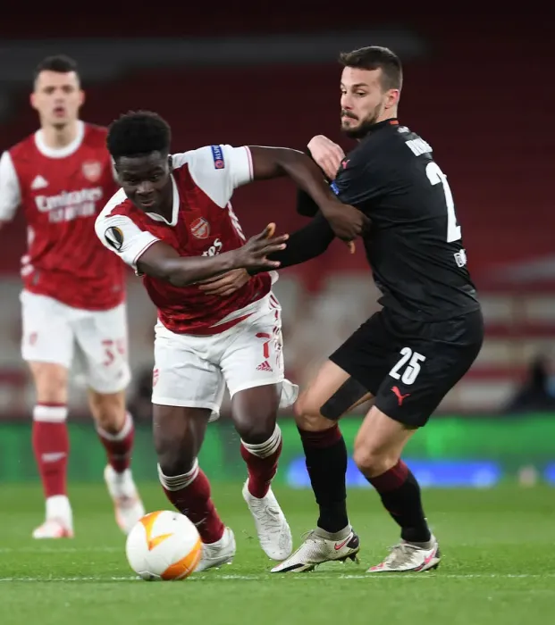 Framed Print : Bukayo Saka in Empty Emirates Stadium: Arsenal's Lone Warrior in Europa League Quarterfinal vs Slavia Praha, London, 2021