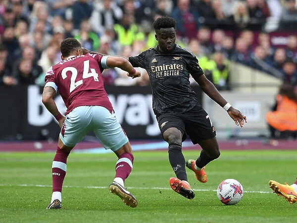 Bukayo Saka Faces Off Against Thilo Kehrer: Intense Moment from West Ham vs. Arsenal Premier League Clash (2022-23)