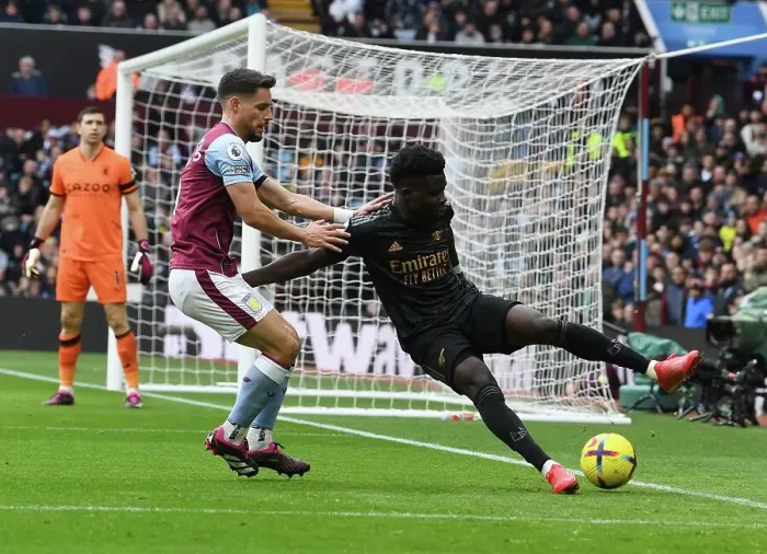 Framed Print : Bukayo Saka vs Alexandre Moreno: Intense Battle at Villa Park - Arsenal vs Aston Villa, Premier League 2022-23
