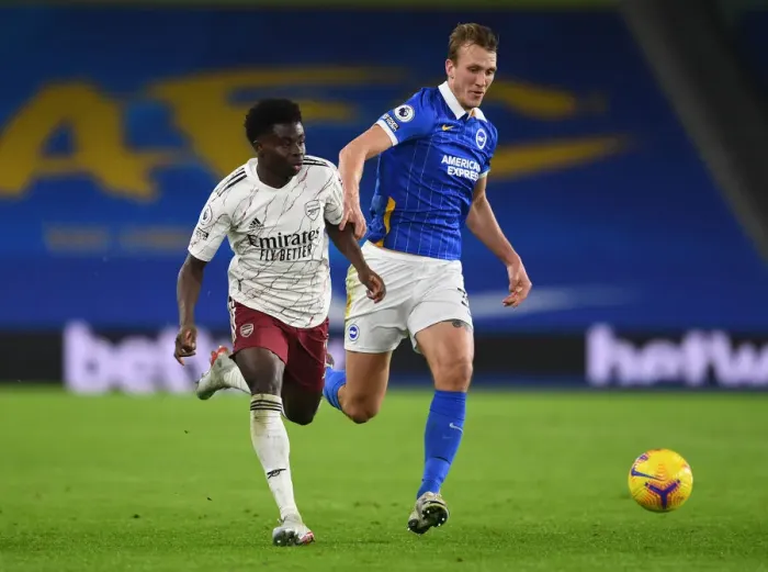 Framed Print : Bukayo Saka vs. Dan Burn: A Fierce Battle – Arsenal's Triumph over Brighton & Hove Albion, Premier League 2020-21