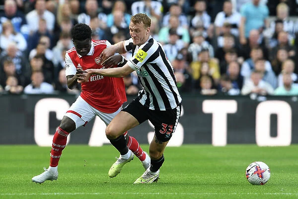 Bukayo Saka vs Dan Burn: Intense Battle at St. James Park - Arsenal vs Newcastle United, Premier League 2022-23