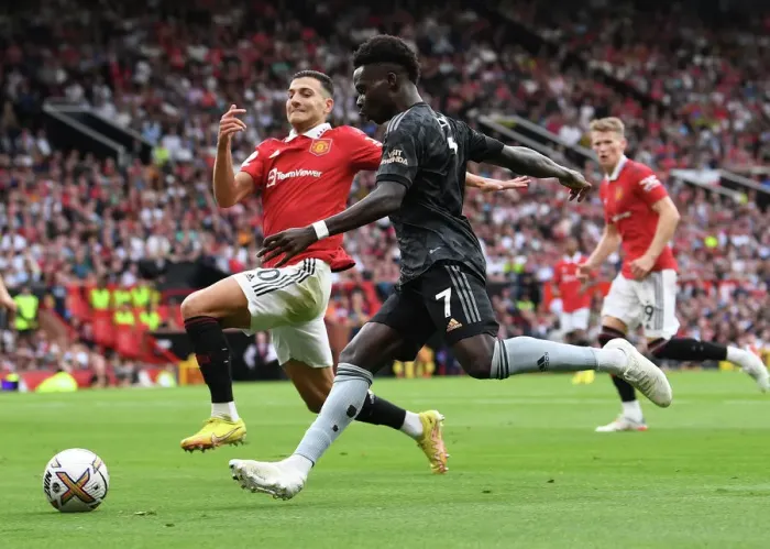 Framed Print : Bukayo Saka vs Diogo Dalot: Intense Battle at Old Trafford - Manchester United vs Arsenal, Premier League 2022-23