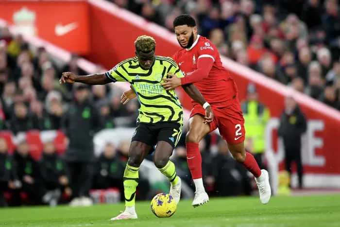 Framed Print : Bukayo Saka vs Joe Gomez: Intense Battle at Anfield - Liverpool vs Arsenal, Premier League 2023-24