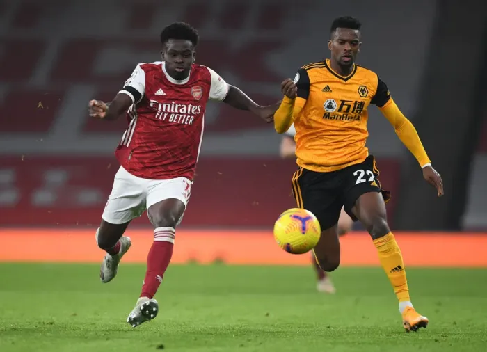 Framed Print : Bukayo Saka vs. Nelson Semedo: A Battle at Empty Emirates - Arsenal vs. Wolverhampton Wanderers (Premier League 2020-21)