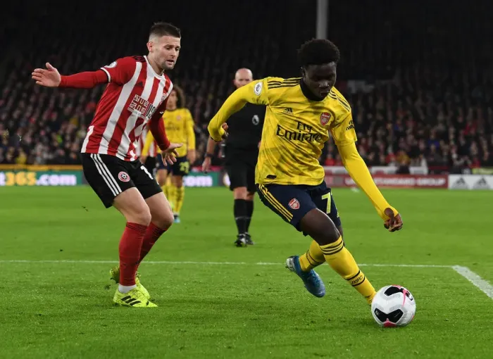 Framed Print : Bukayo Saka vs Ollie Norwood: Battle at Bramall Lane - Sheffield United vs Arsenal FC, Premier League 2019-20